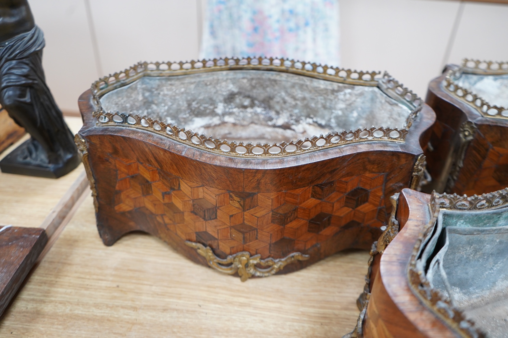 A pair of French Transitional style kingwood and parquetry table jardinières and one other, 43cm wide